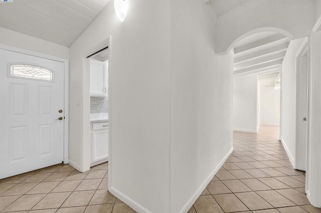 tiled foyer with lofted ceiling