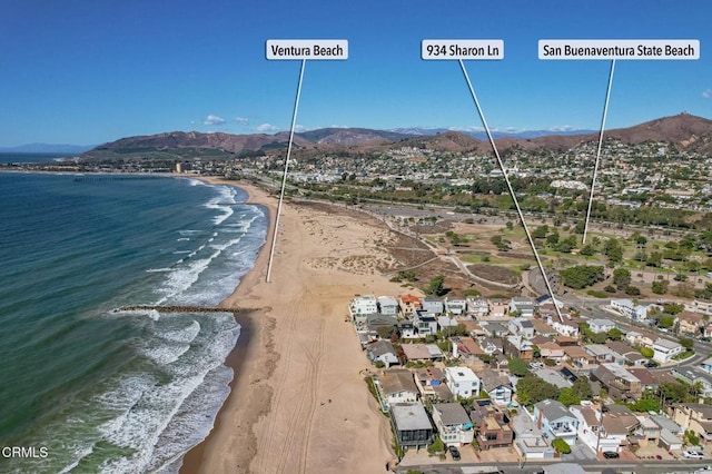 birds eye view of property featuring a beach view and a water and mountain view