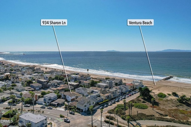 aerial view with a water view and a beach view