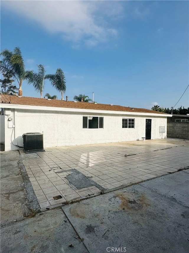 rear view of property featuring a patio area and central AC