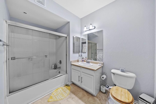 full bathroom featuring combined bath / shower with glass door, vanity, and toilet