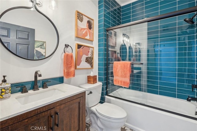 full bathroom featuring combined bath / shower with glass door, vanity, and toilet