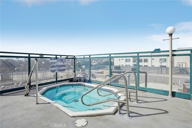 view of swimming pool featuring a community hot tub