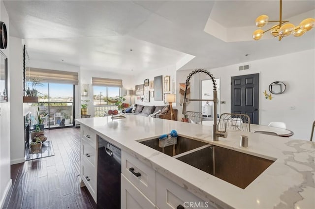 kitchen featuring light stone countertops, dark hardwood / wood-style flooring, sink, white cabinets, and black dishwasher