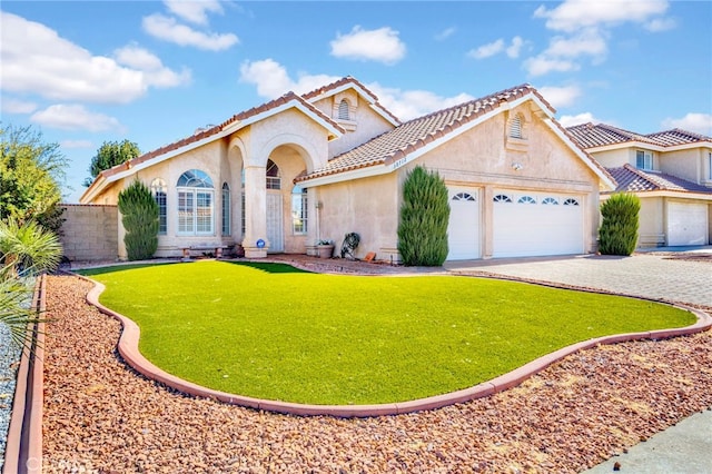 mediterranean / spanish-style house with a front lawn and a garage