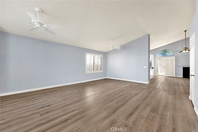 unfurnished living room featuring ceiling fan, wood-type flooring, and lofted ceiling