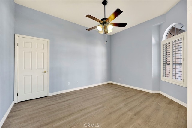 empty room with ceiling fan and light wood-type flooring