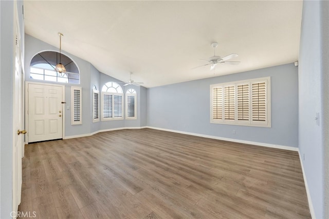 foyer entrance with light hardwood / wood-style flooring and lofted ceiling