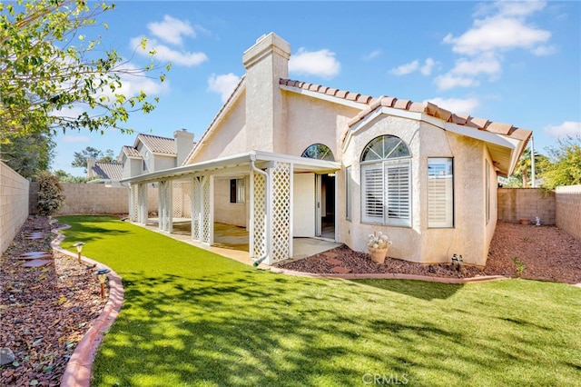 rear view of property featuring a patio area and a yard