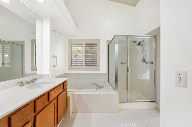 bathroom with tile patterned floors, vanity, and shower with separate bathtub