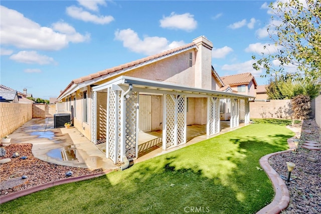 back of property with a patio and central AC