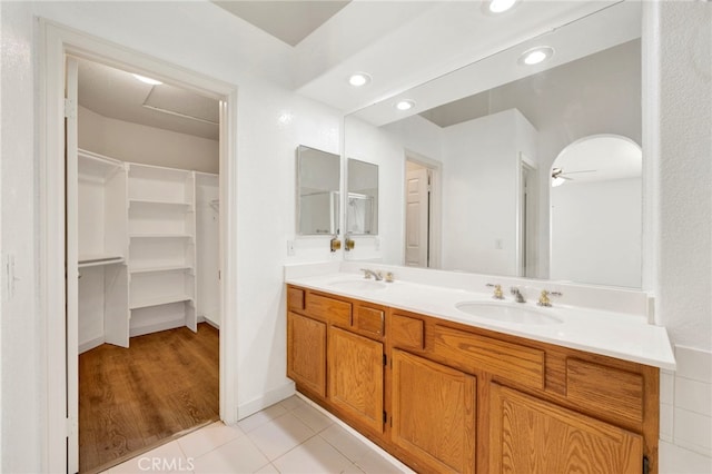 bathroom featuring tile patterned flooring, vanity, and ceiling fan