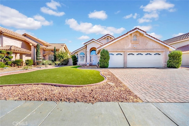 view of front of house with a front yard and a garage