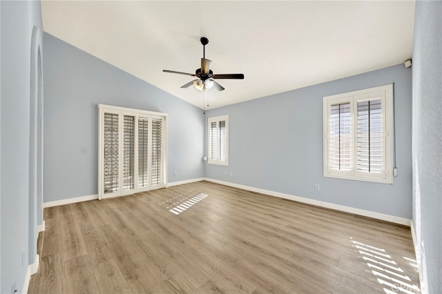 unfurnished bedroom with ceiling fan, lofted ceiling, and light hardwood / wood-style flooring