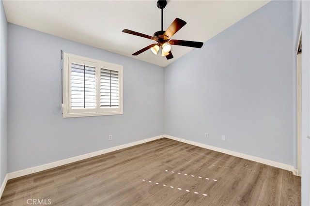 empty room with ceiling fan and hardwood / wood-style floors