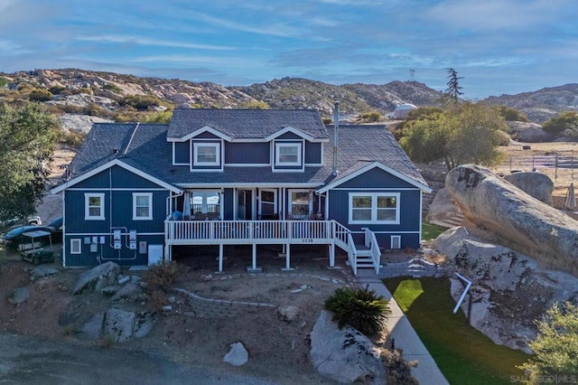 back of house with a deck with mountain view