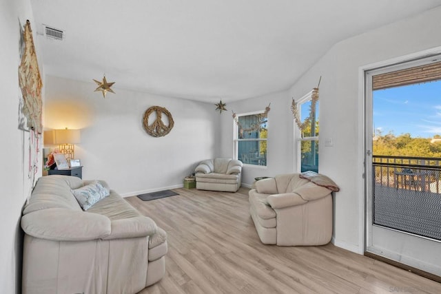 living room with light wood-type flooring and a healthy amount of sunlight