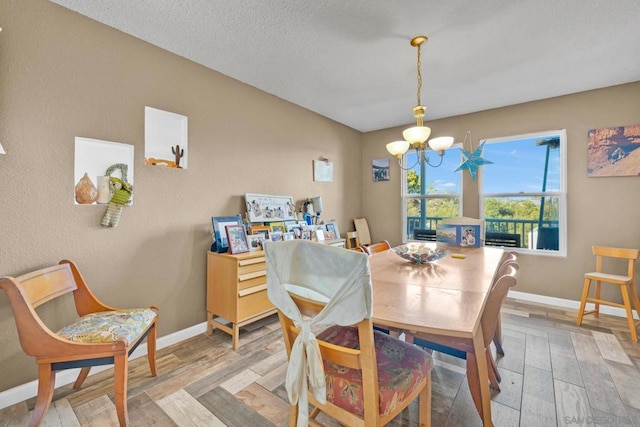 dining room featuring a notable chandelier and light hardwood / wood-style floors