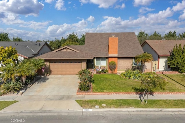 view of front of property featuring a garage and a front lawn