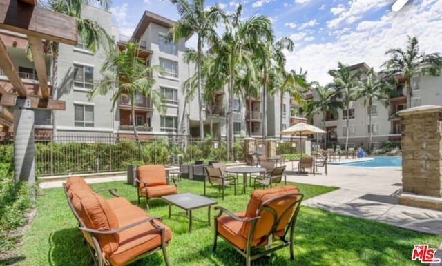 view of community with a yard and a pool