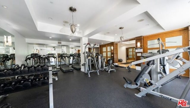 gym featuring a tray ceiling