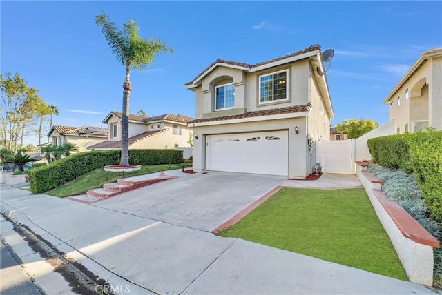 mediterranean / spanish home with a garage and a front lawn