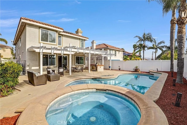 rear view of property with a swimming pool with hot tub, a patio area, and a pergola