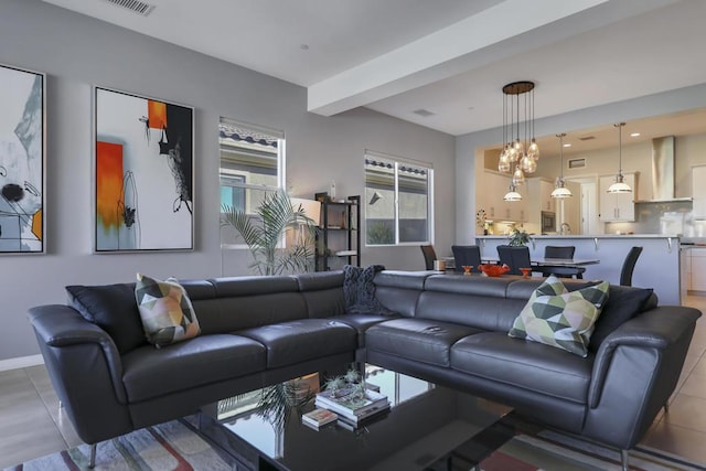 tiled living room featuring beamed ceiling