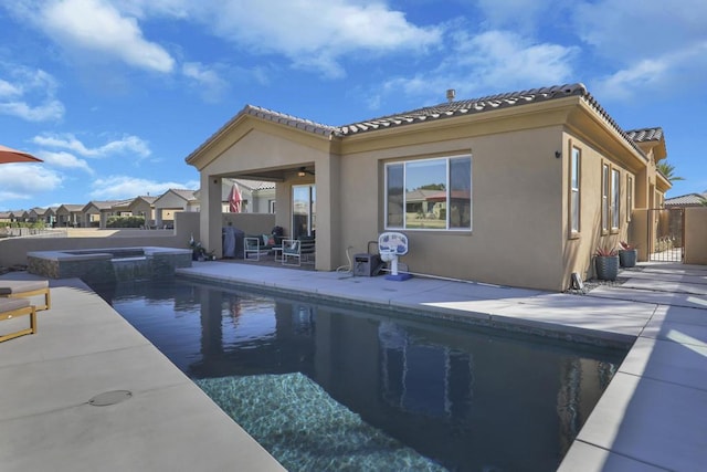 view of swimming pool featuring an in ground hot tub and a patio