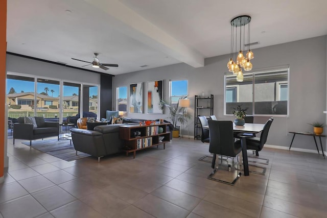 dining space with ceiling fan, a wealth of natural light, and beam ceiling