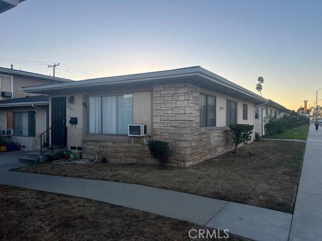 view of front of house featuring an AC wall unit