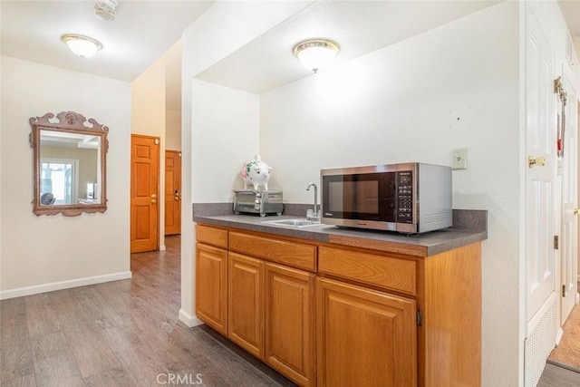 kitchen featuring light wood-type flooring and sink