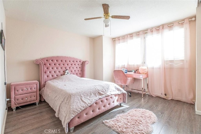 bedroom with hardwood / wood-style flooring and ceiling fan