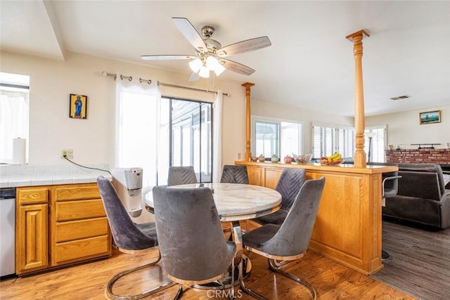 dining area with ceiling fan and light hardwood / wood-style floors