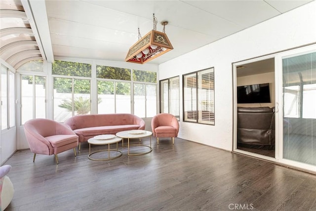 sunroom / solarium featuring beam ceiling and a wealth of natural light