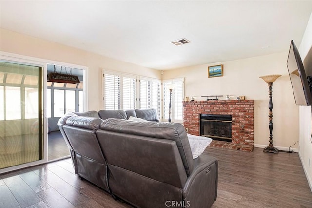 living room with a fireplace and dark hardwood / wood-style flooring