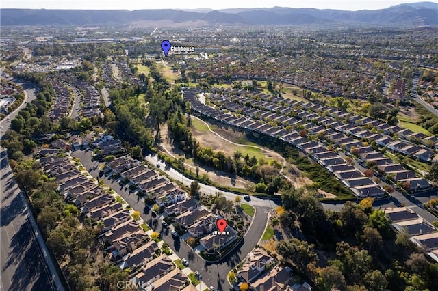 birds eye view of property with a mountain view