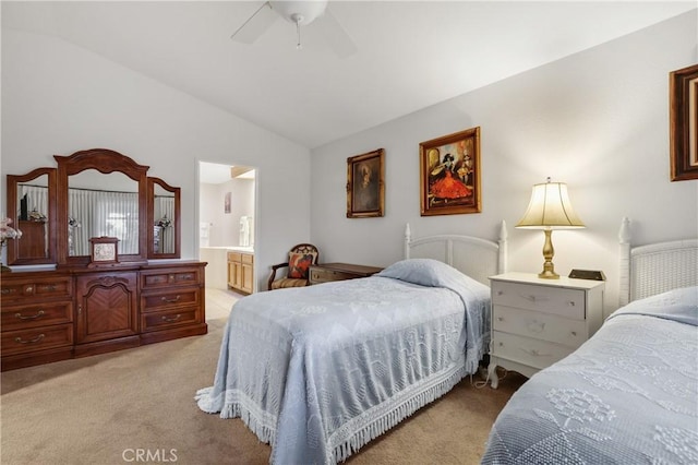 bedroom with ceiling fan, lofted ceiling, connected bathroom, and light colored carpet