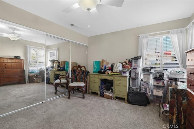 home office with ceiling fan and light colored carpet