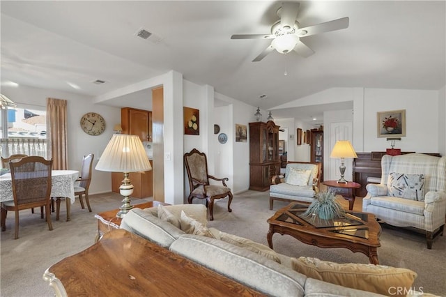 carpeted living room featuring ceiling fan and vaulted ceiling