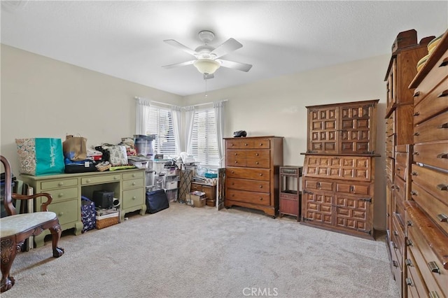 interior space featuring ceiling fan and light colored carpet