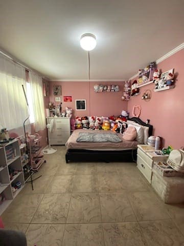 bedroom with ornamental molding