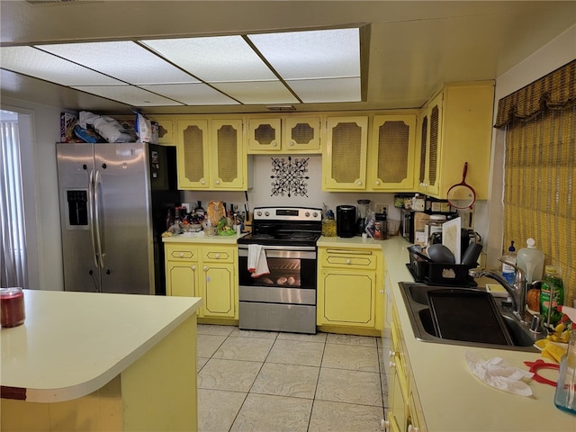 kitchen with light tile patterned flooring, sink, and appliances with stainless steel finishes