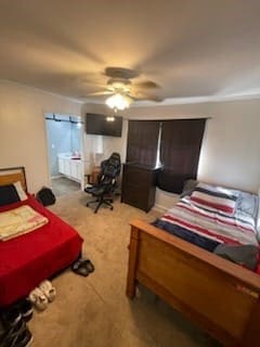 carpeted bedroom featuring ceiling fan and ensuite bathroom