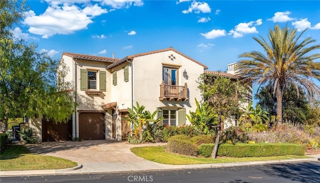 mediterranean / spanish-style home with a balcony and a garage