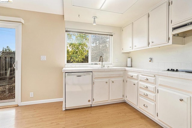 kitchen with tile countertops, sink, white appliances, and white cabinetry