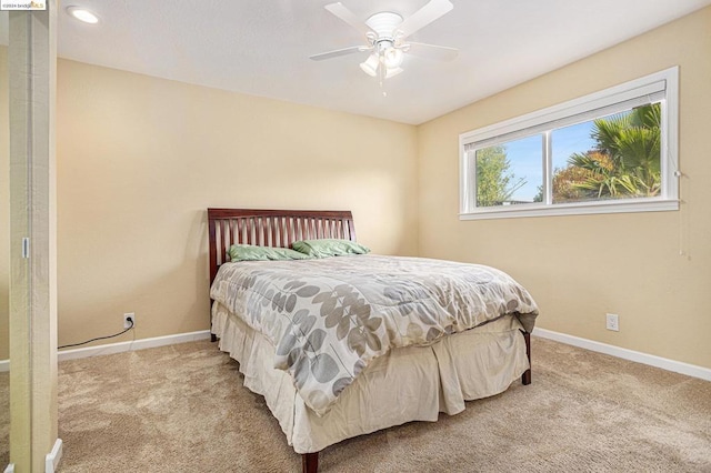 bedroom featuring light carpet and ceiling fan