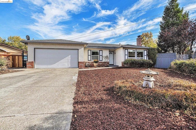 ranch-style house with a garage and a storage shed