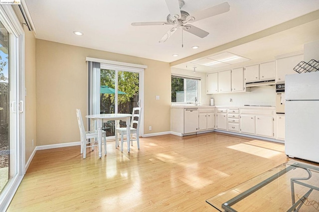 kitchen with ceiling fan, white appliances, white cabinets, and light wood-type flooring