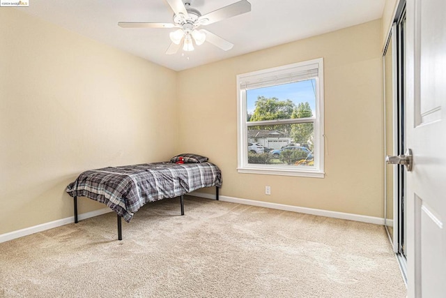 bedroom featuring ceiling fan and light colored carpet